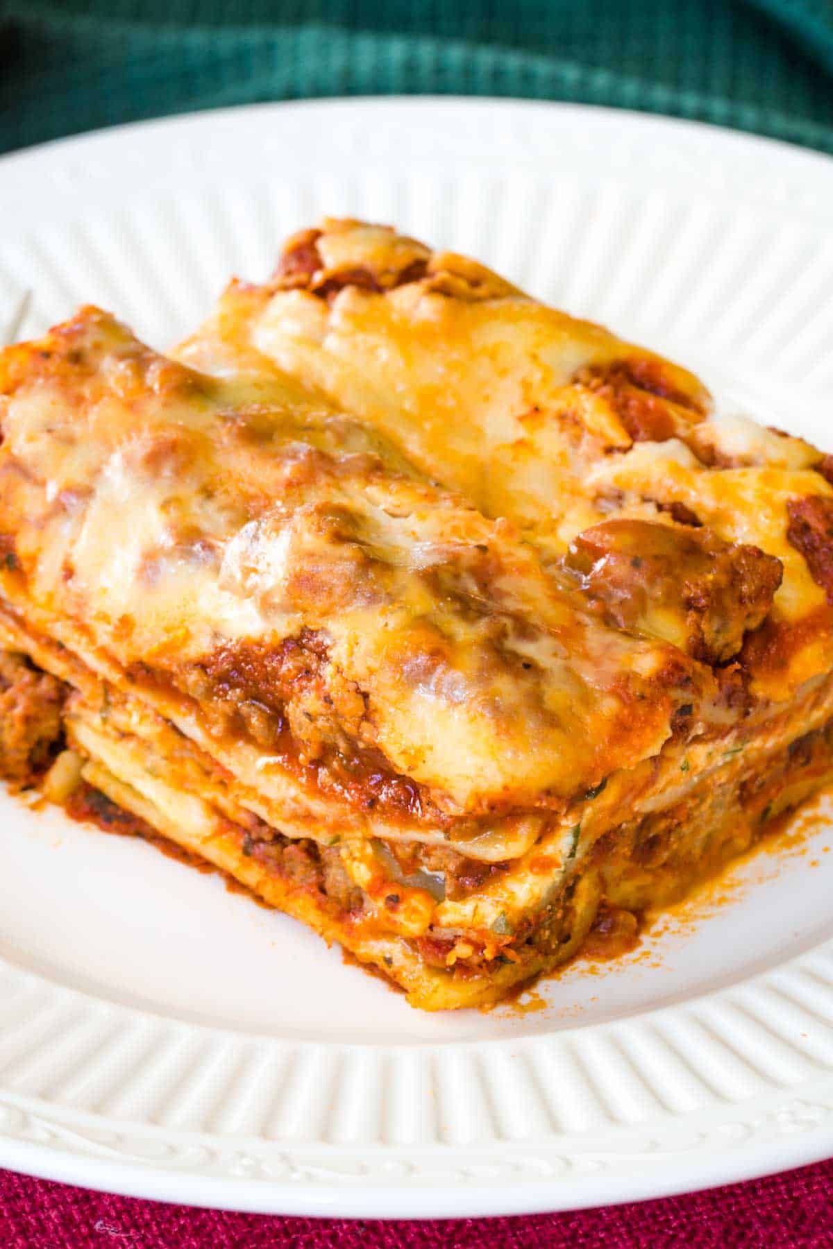 Overhead of a piece of Lasagna on a plate.