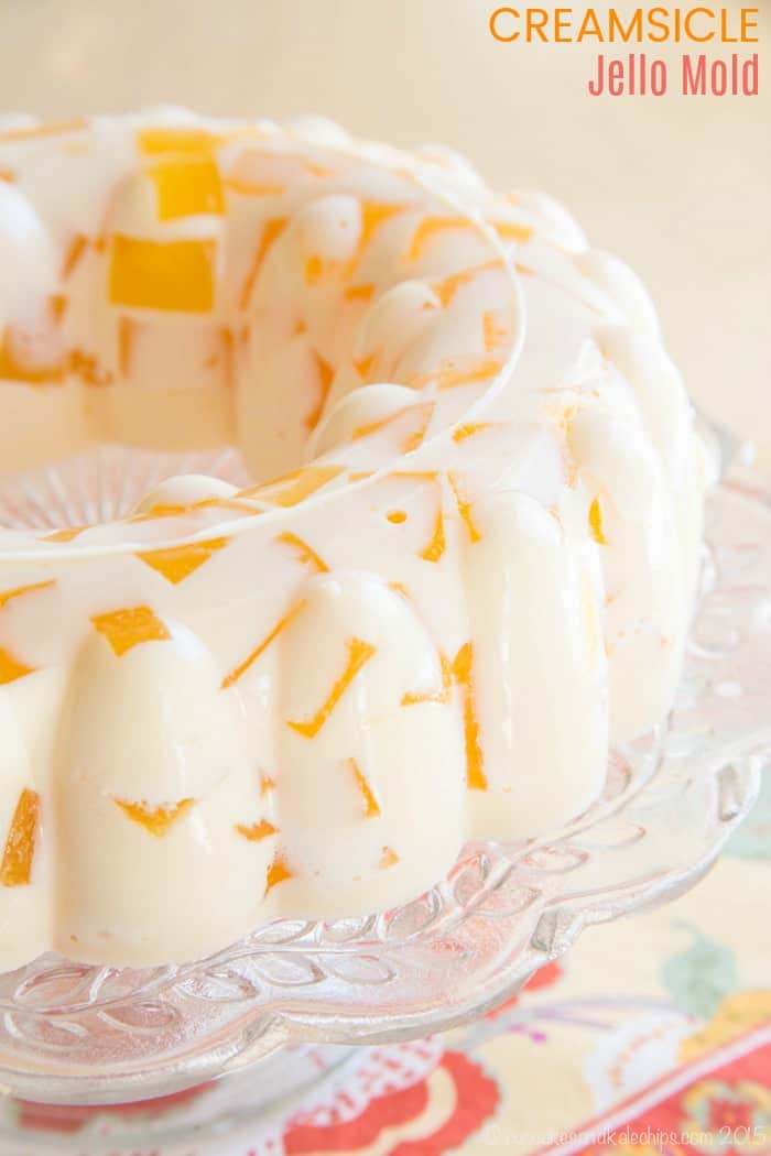 Orange Creamsicle Jello Mold recipe served on a glass cake pedestal