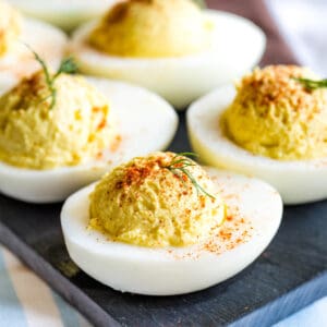 Healthy Deviled Eggs with a sprinkle of paprika and garnish of dill.