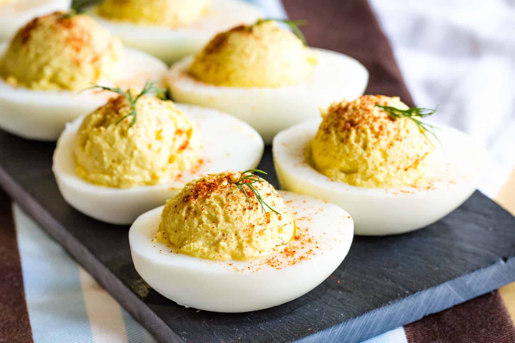 Greek Yogurt Deviled Eggs on a slate serving platter.