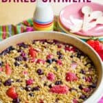 Baked oatmeal with different berries in a round baking dish with text overlay that says "Mixed Berry Baked Oatmeal".