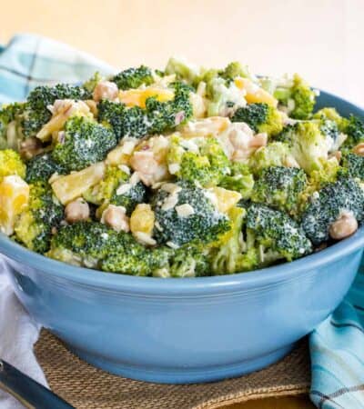 Tropical Pineapple Broccoli Salad in a blue serving bowl with a spoon