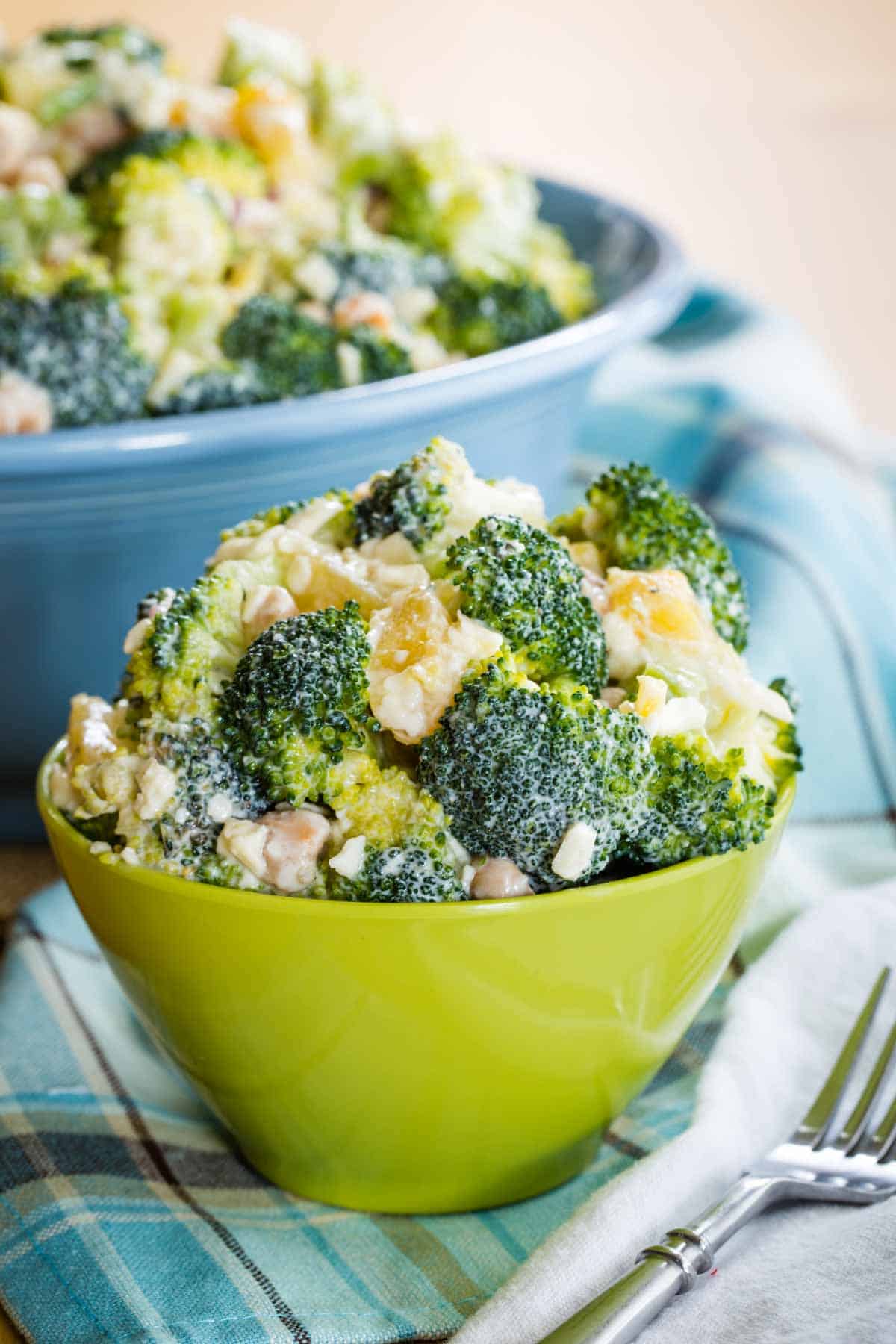 Tropical Broccoli Salad in a green bowl with a fork next to it.