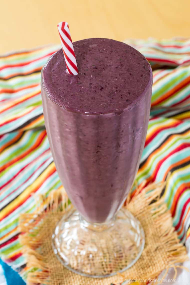 Cherry Almond Milk Smoothie in a glass with a striped straw