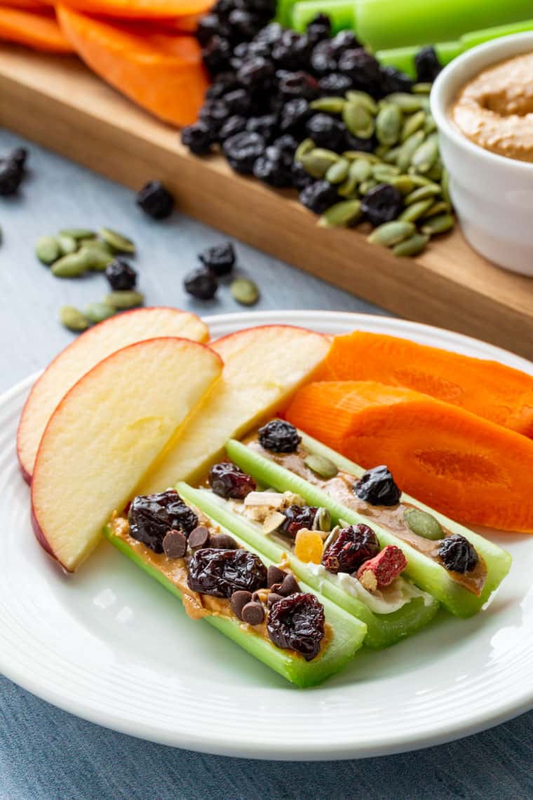 closeup of three versions of Ants on a Log with carrots and apples