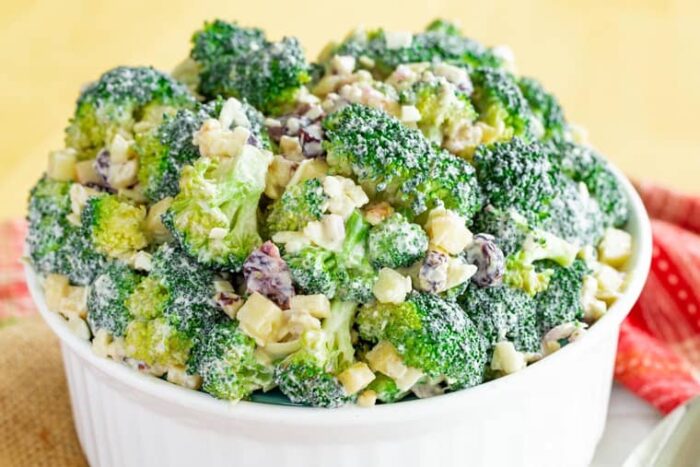 A white serving bowl of Healthy Apple Broccoli Salad with Walnuts and Cheddar