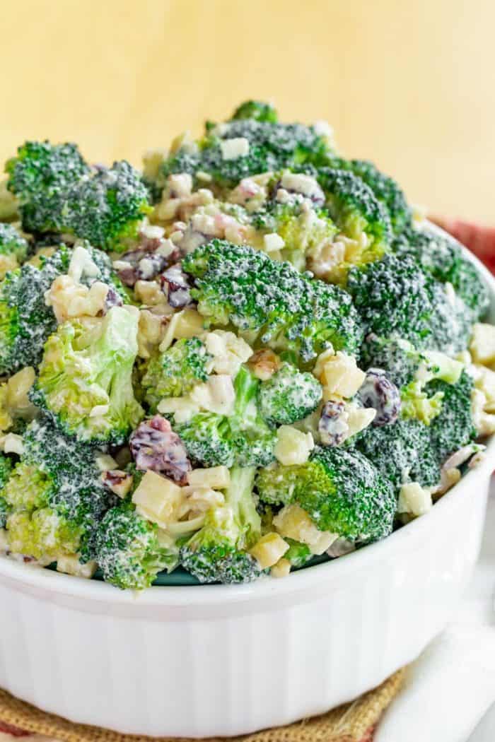 Closeup of No Mayo Broccoli Salad with apples, walnuts, dried cranberries, and cheddar cheese
