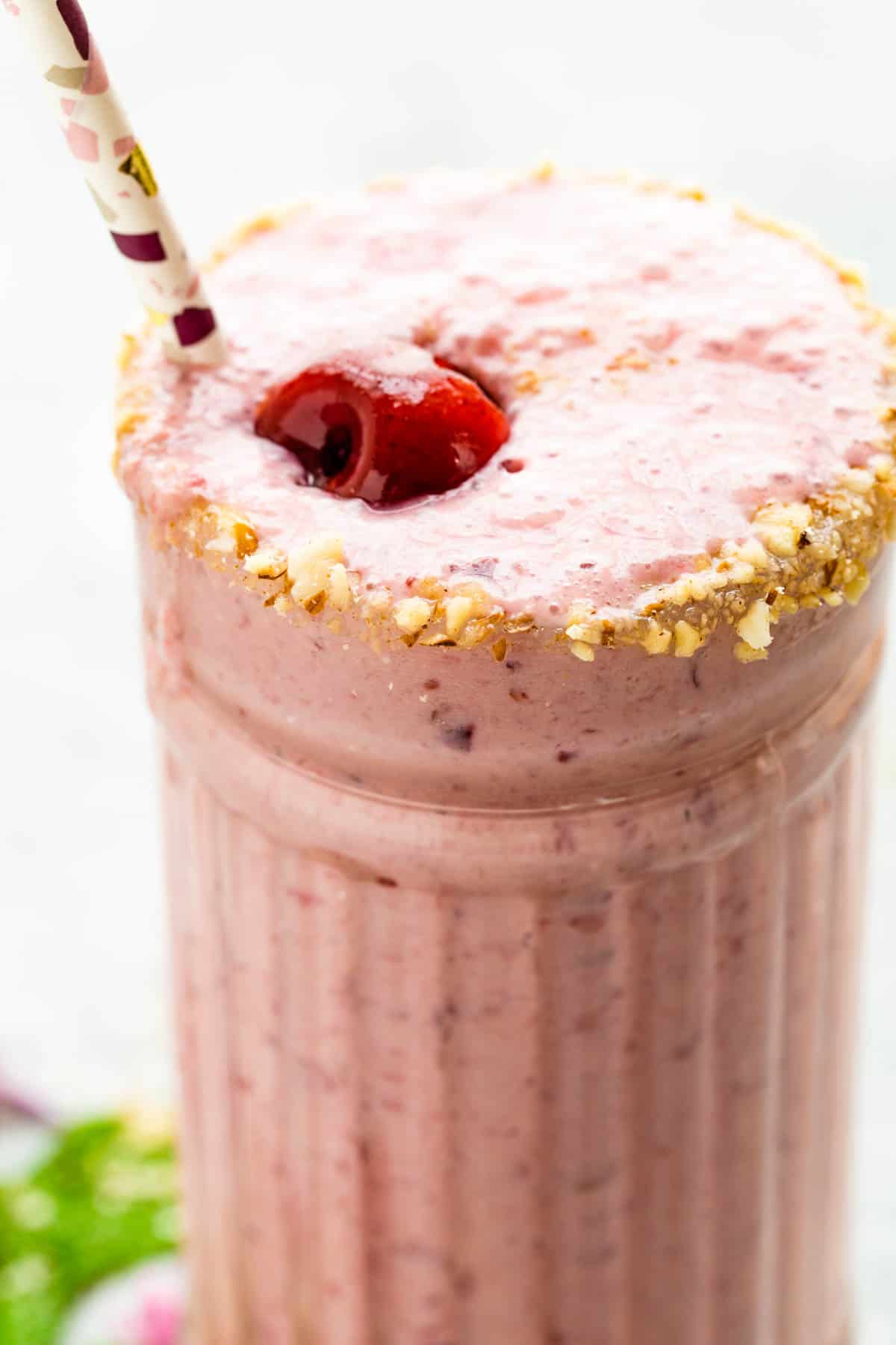 Closeup of Cherry Cheesecake Smoothie with a cherry on top.