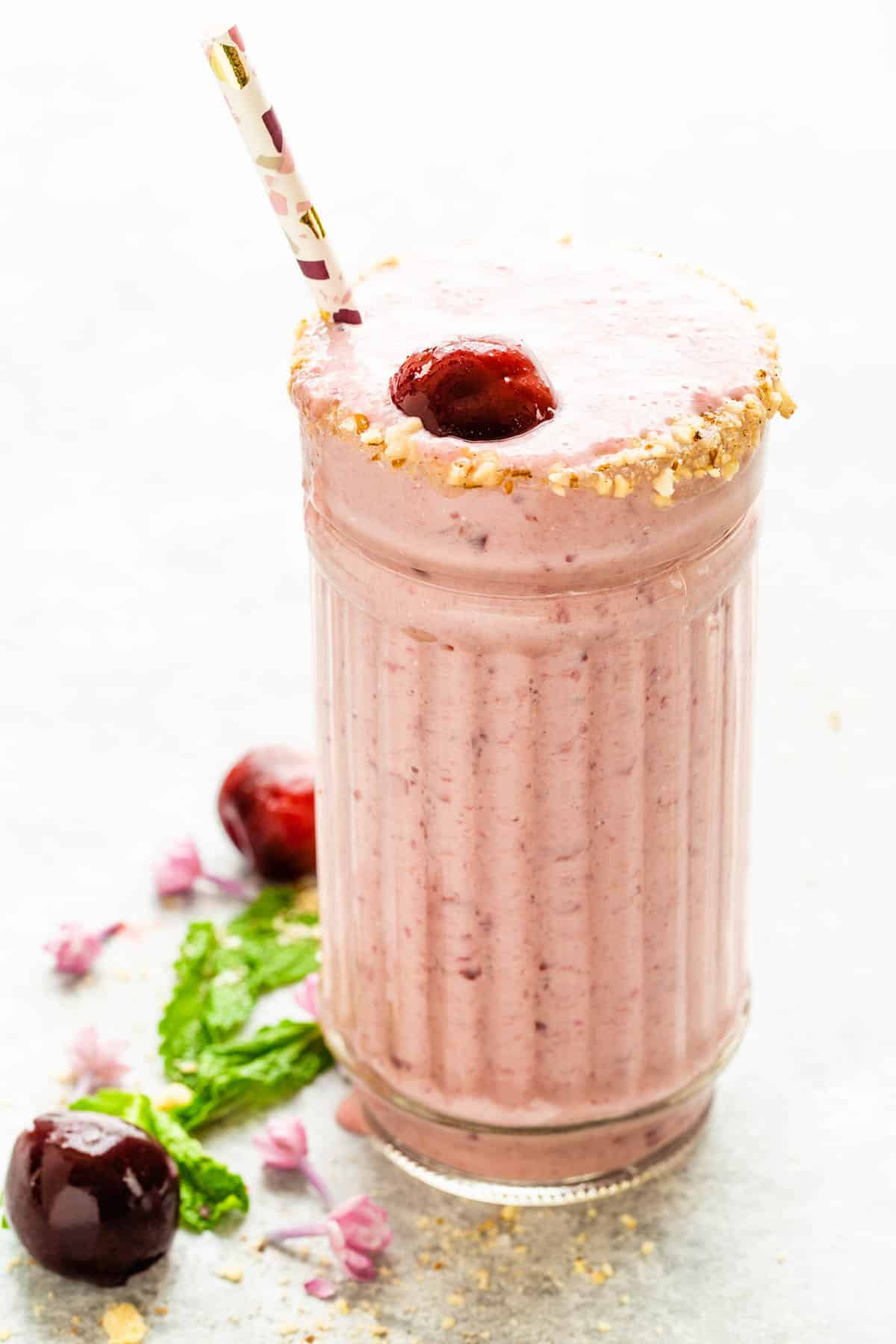 Cherry Smoothie that tastes like cheesecake with a crust rim garnish