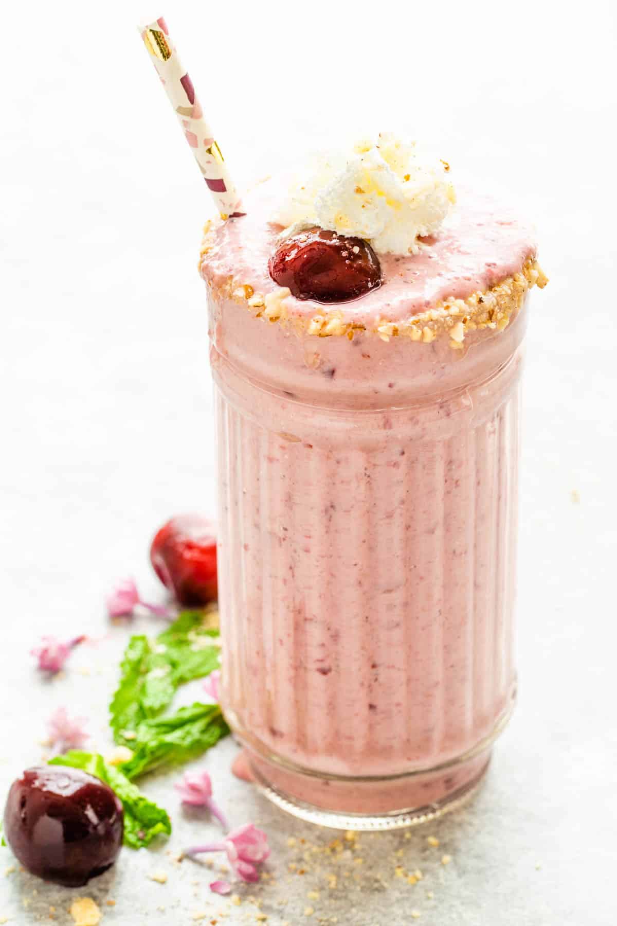 Cherry Cheesecake Smoothie with whipped cream and a cherry.