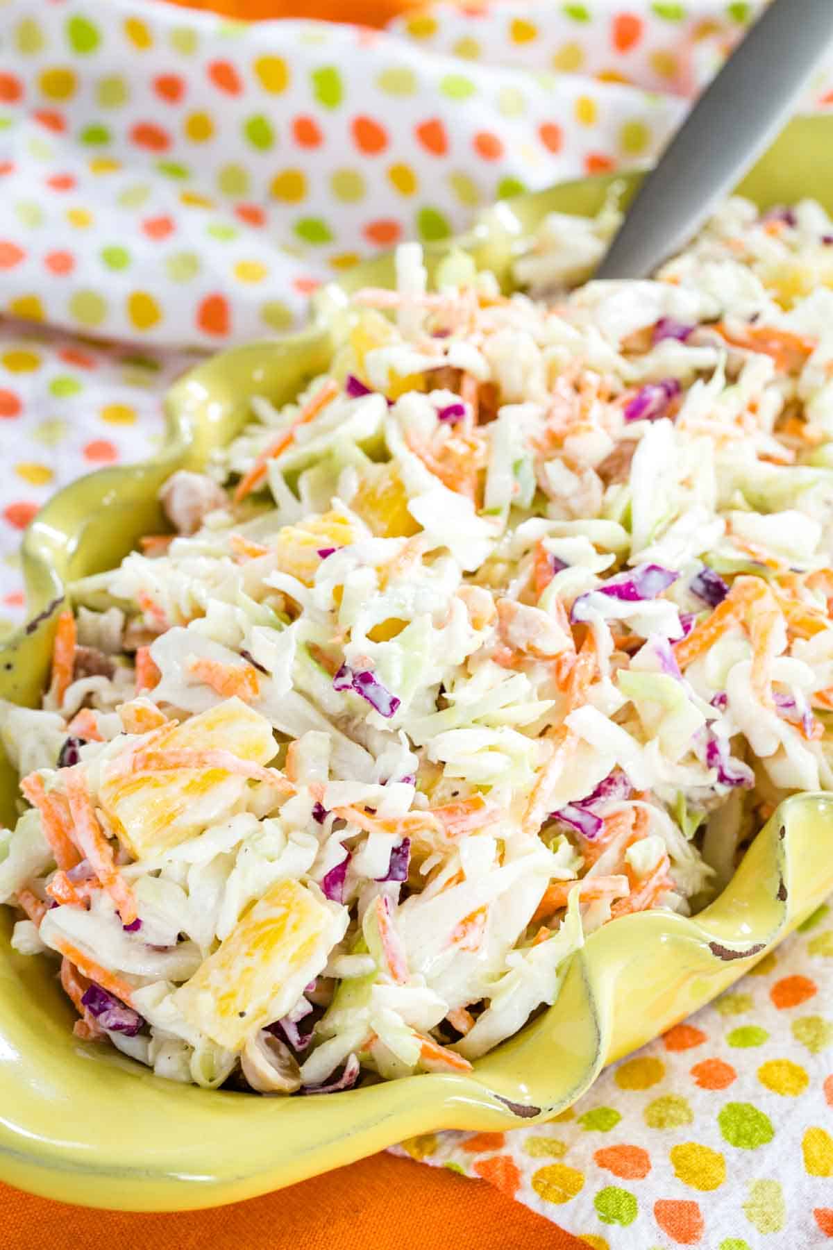 Closeup of Hawaiian Pineapple Coleslaw in an oval yellow ceramic dish.