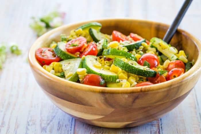 Sauteed Zucchini, Squash, Tomatoes, and Corn in Brown Butter in a wooden serving bowl
