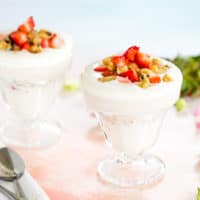 Low Carb Strawberry Cheesecake Parfaits in sundae glasses with small silver spoons