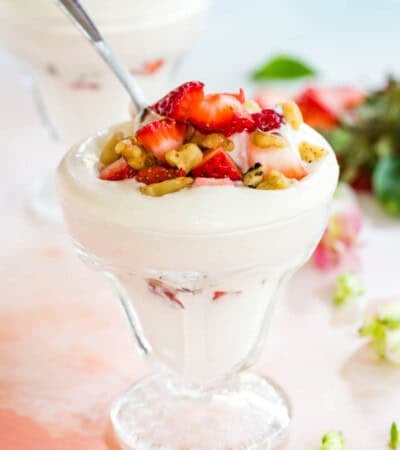 Getting a bite of a Strawberry Cheesecake Parfait with a spoon.