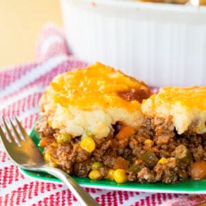 A serving of Shepherd's Pie on a green plate.