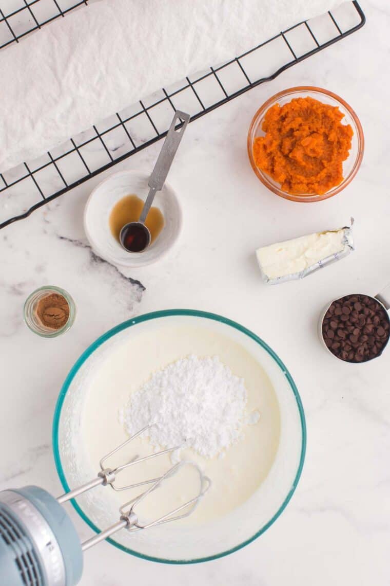 Whipping cream in a bowl with sugar