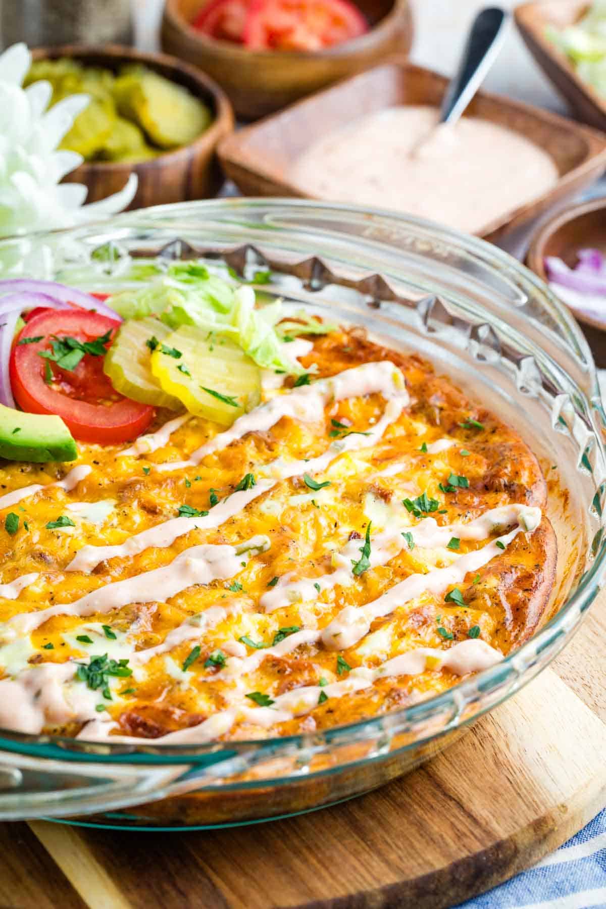 Bacon Cheeseburger Crustless Quiche is made with ground beef, bacon, and cheese, plus your favorite burger toppings. Overhead side view of a bacon cheeseburger qucihe