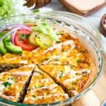 A bacon cheeseburger crustless quiche with a few pieces lsiced