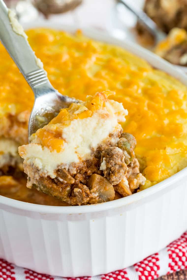 A spoonful of low carb Shepherd's Pie with Cauliflower Mash and cheddar cheese