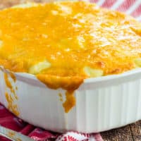 A white baking dish with Low Carb Shepherd's Pie and cheese on top and down the sides