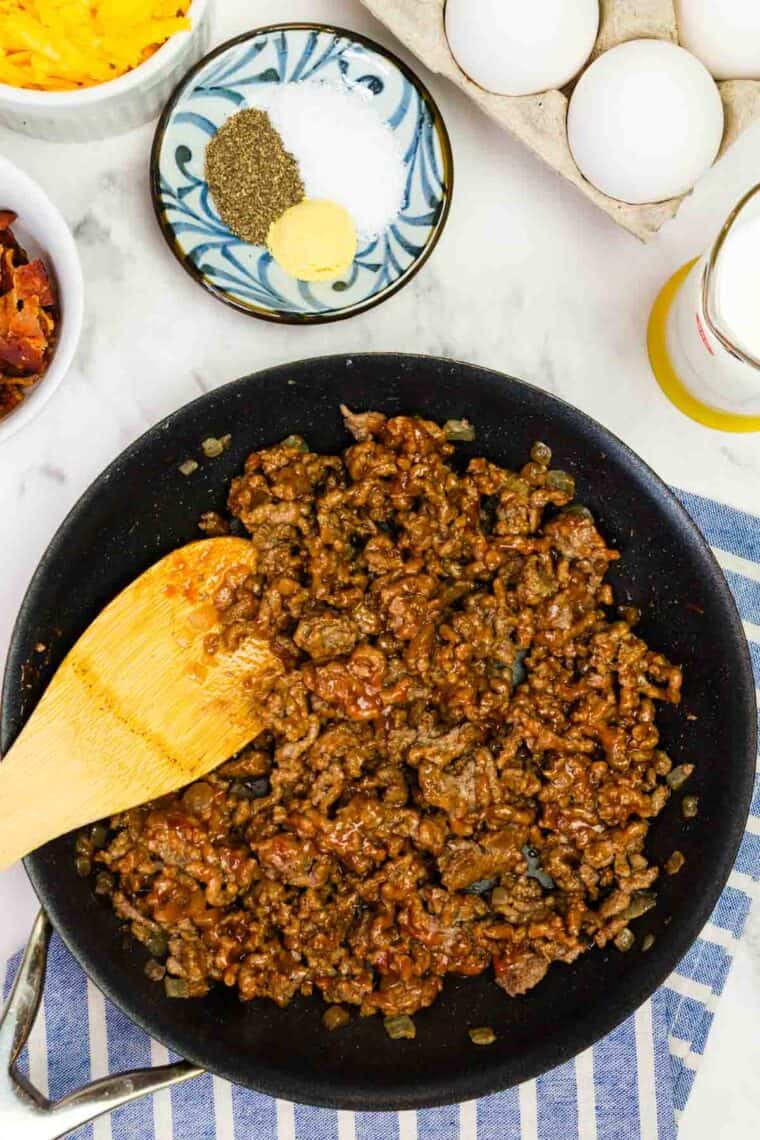 Bacon Cheeseburger Crustless Quiche is made with ground beef, bacon, and cheese, plus your favorite burger toppings. Stirring mustard and ketchup into ground beef