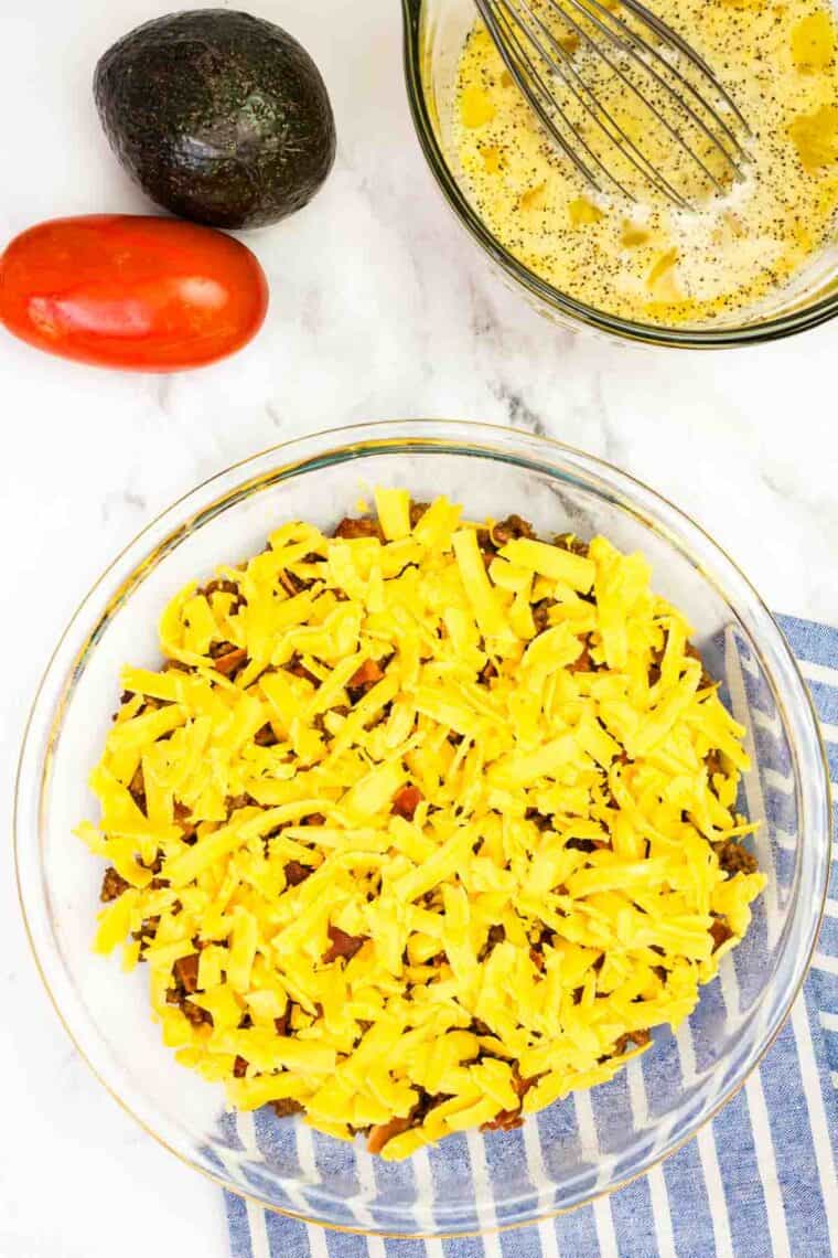 Bacon Cheeseburger Crustless Quiche is made with ground beef, bacon, and cheese, plus your favorite burger toppings. Cheddar cheese on top of ground beef and bacon