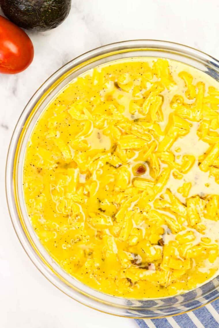 Bacon Cheeseburger Crustless Quiche is made with ground beef, bacon, and cheese, plus your favorite burger toppings. Egg mixture on top of ground beef, bacon, and cheese in a pie plate