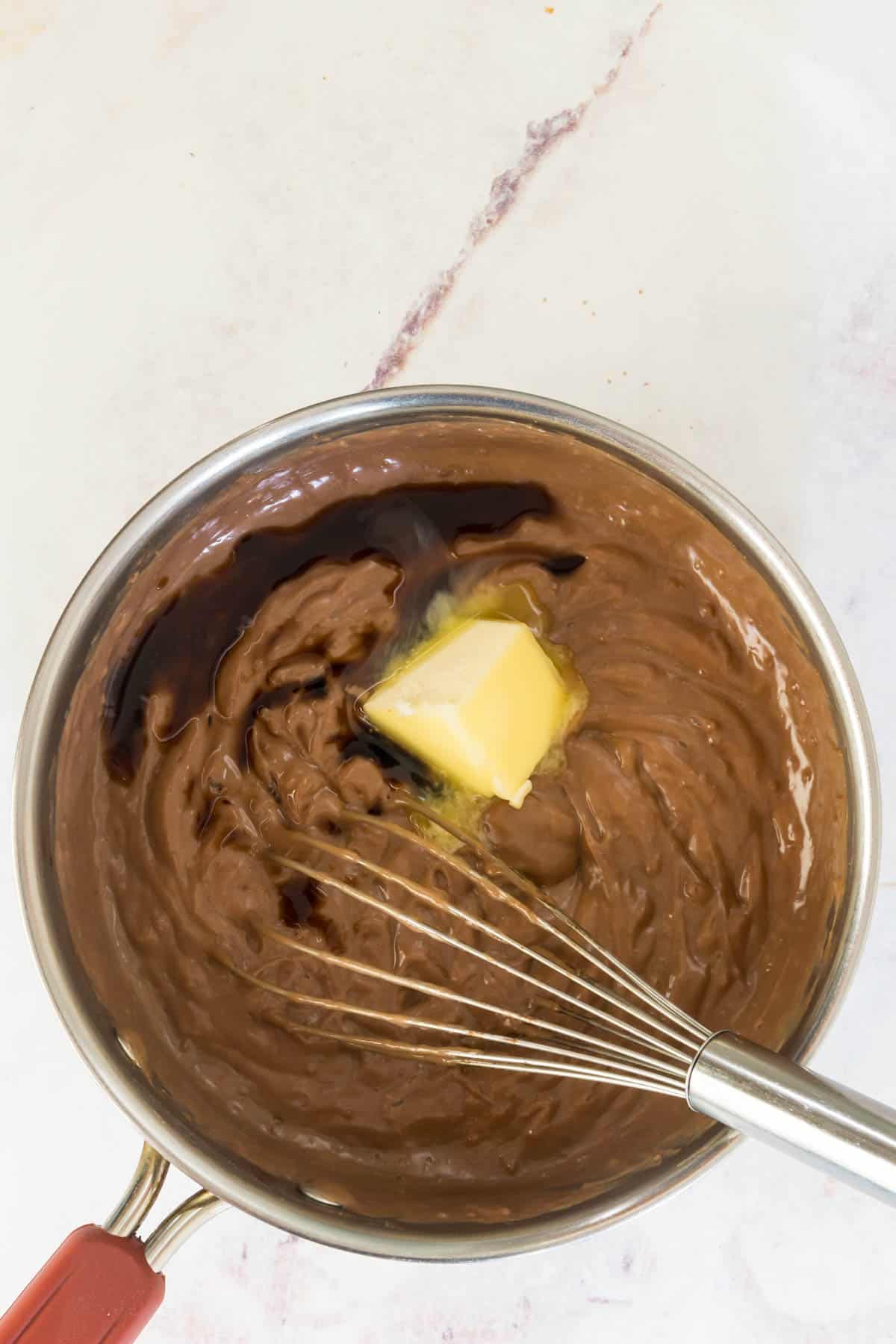 Butter and vanilla is added into a saucepan with the chocolate pudding base.