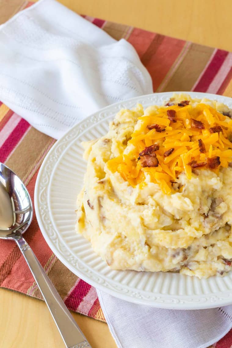 Cheesy Bacon Mashed Potatoes with even more cheddar cheese on top