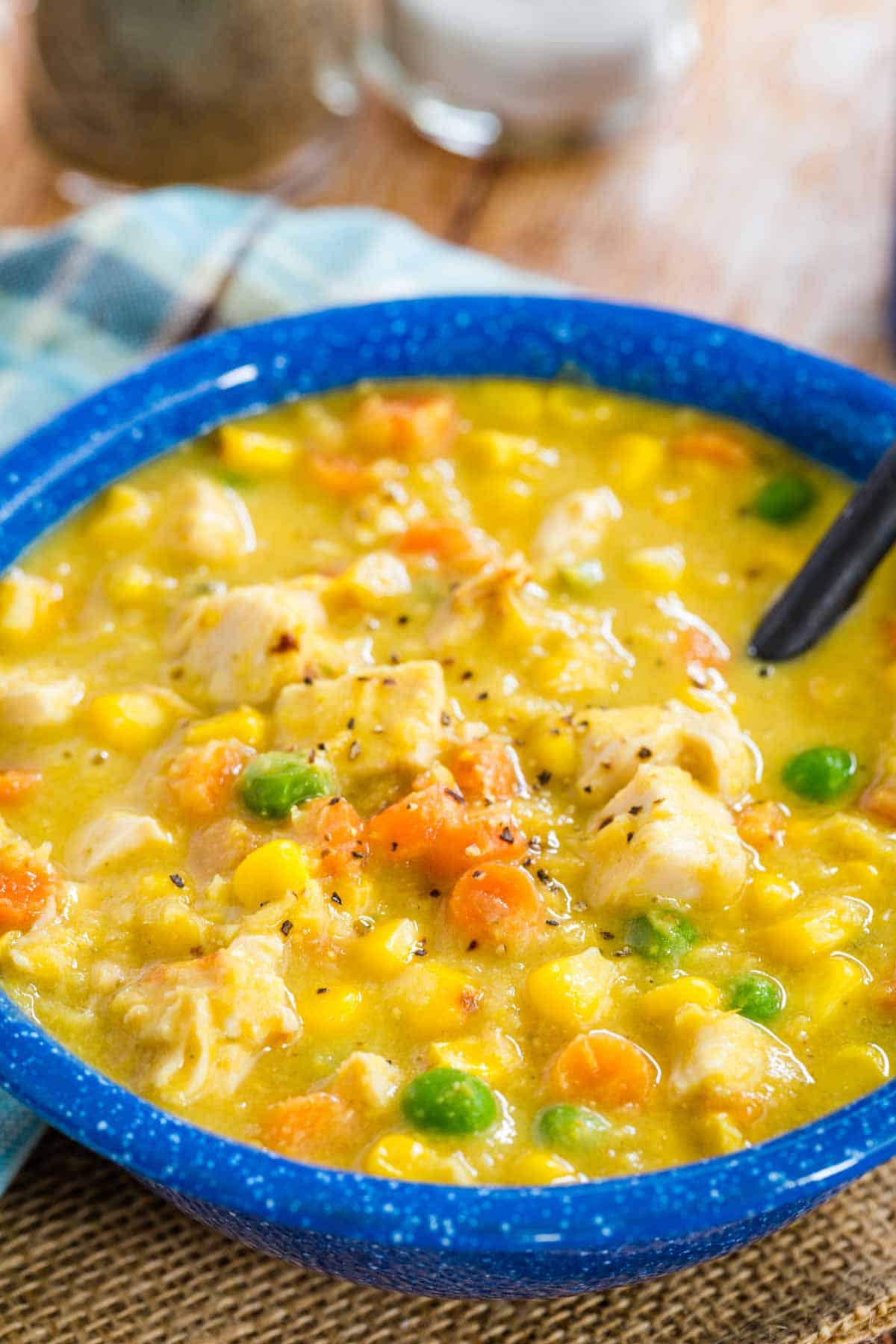 Closeup of a bowl of Gluten Free Chicken Corn Chowder with pepper sprinkled on top.