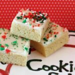 Frosted Sugar Cookie bars with Christmas Sprinkles on a cookie plate