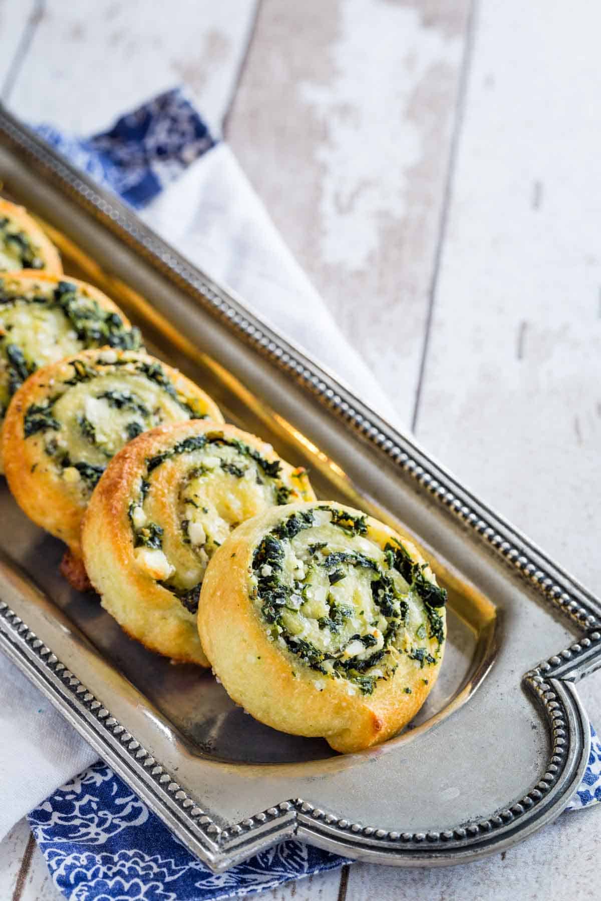 Low Carb Spinach Feta Pinwheels on a silver platter