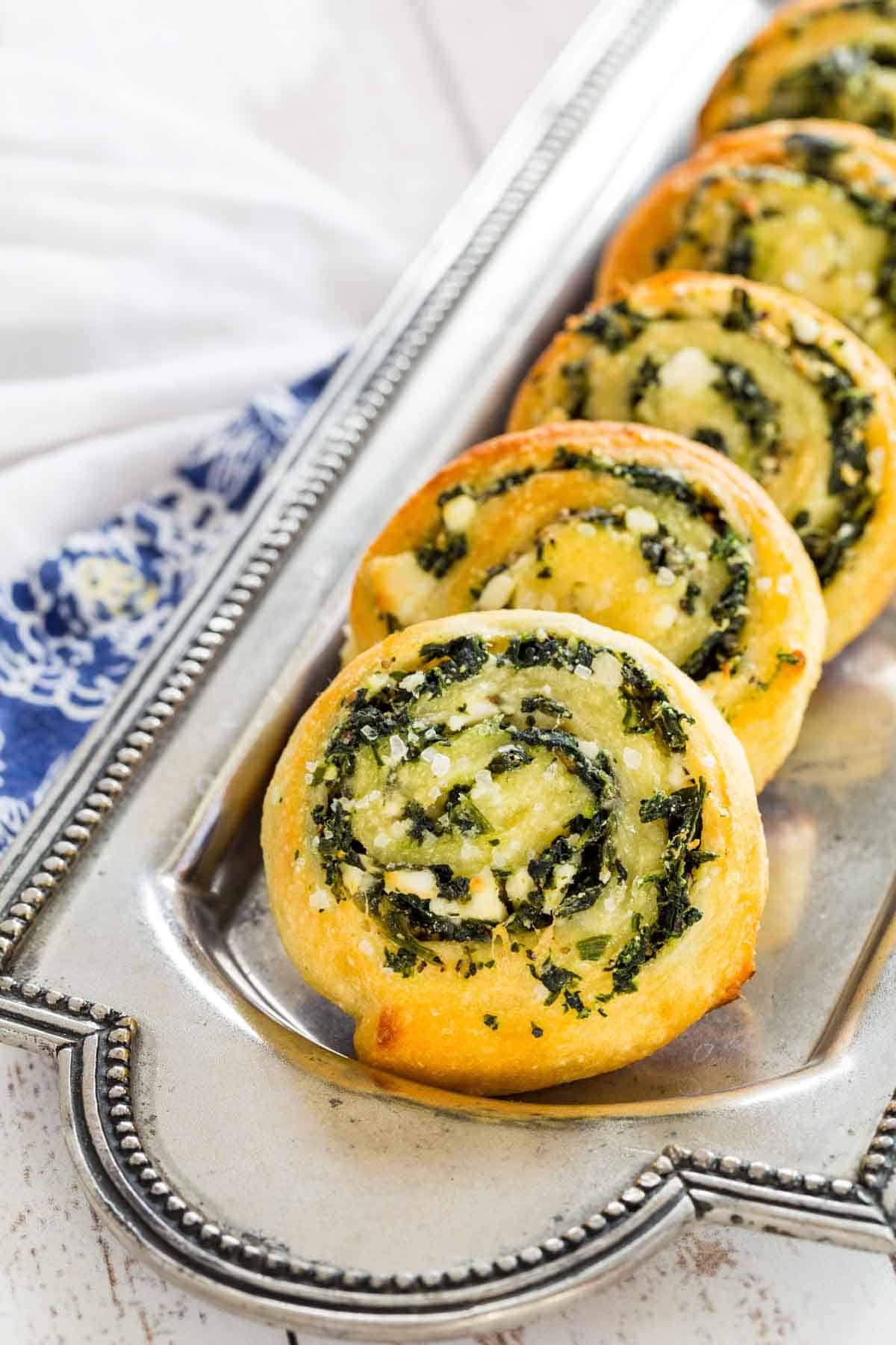 A serving plate of Spinach Feta Appetizer Pinwheels.