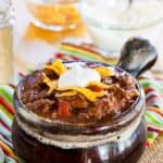 Low Carb Chili without Beans in a crock with bowls of cheese and sour cream for topping