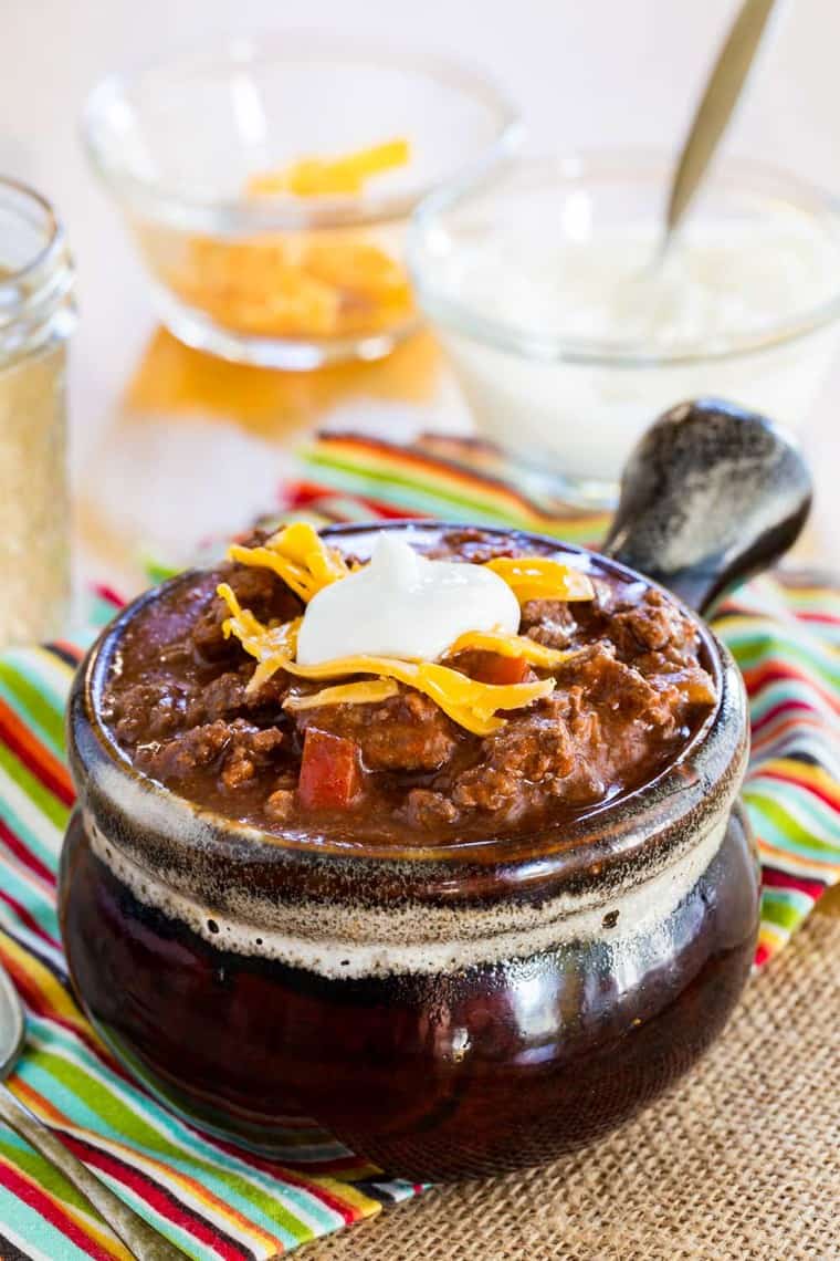 Low Carb Chili without Beans in a crock with bowls of cheese and sour cream for topping