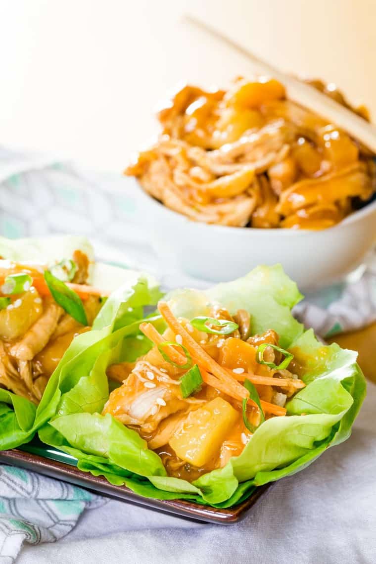 Teriyaki Chicken Lettuce Wraps topped with scallions, sesame seeds, and carrots