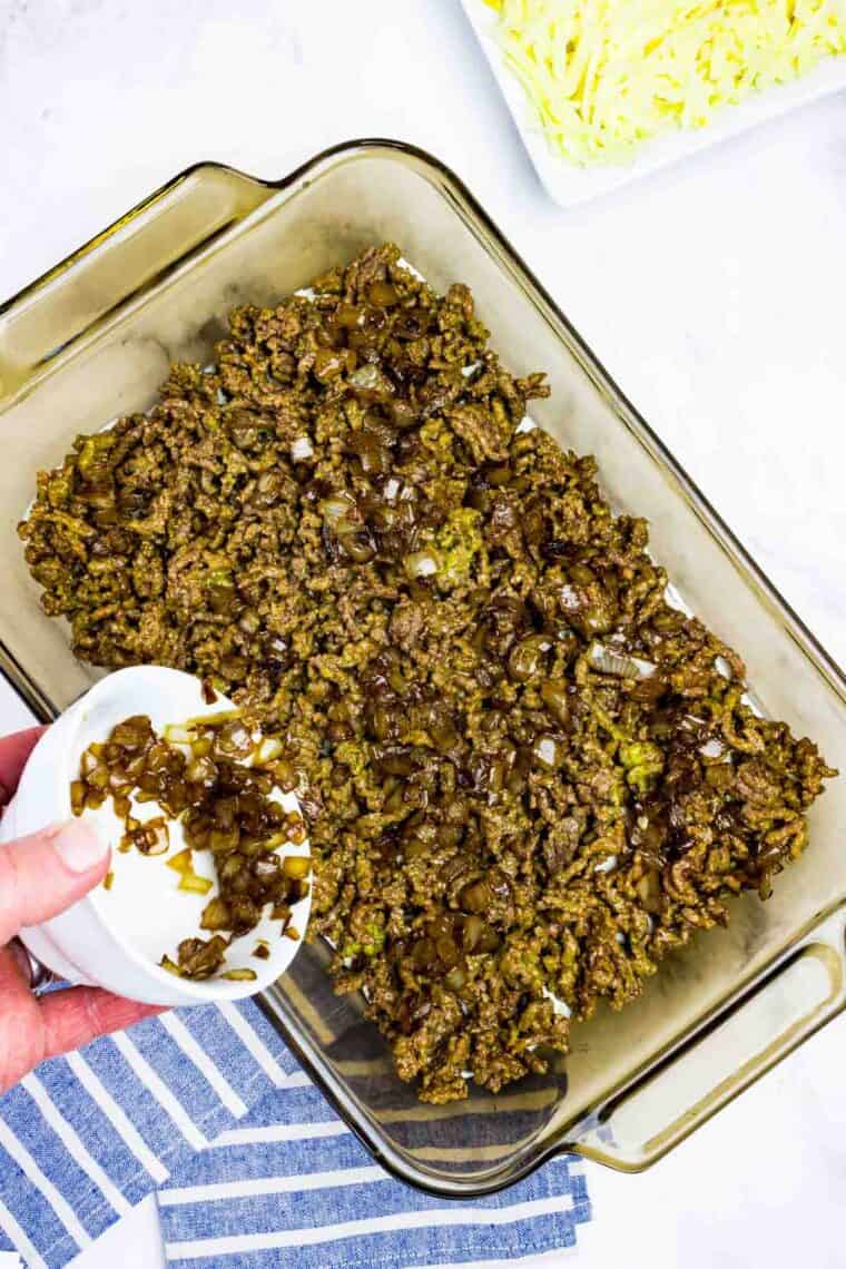 Caramelized onion on top of ground beef in a baking dish