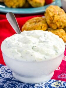 Easy Tzatziki Sauce in a White bowl with falafel in background