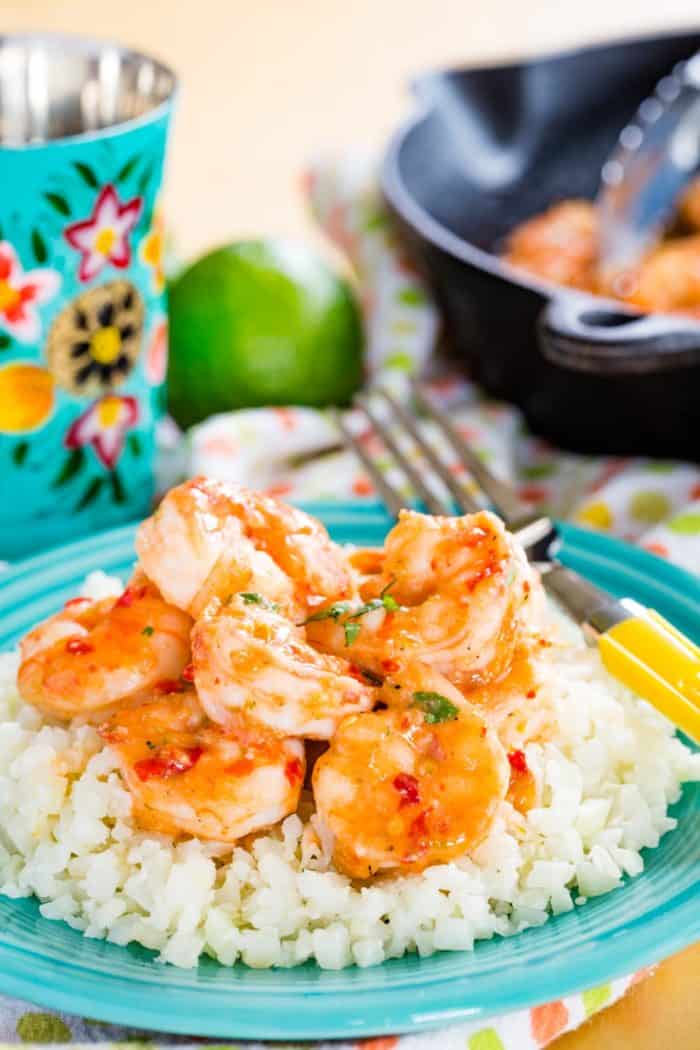 Honey Lime Chili Shrimp on a turquoise plate over cauliflower rice