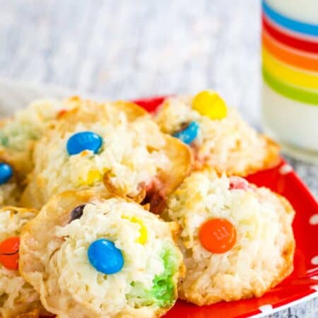 Coconut Macaroons with M&M's chocolate candies on a red plate.
