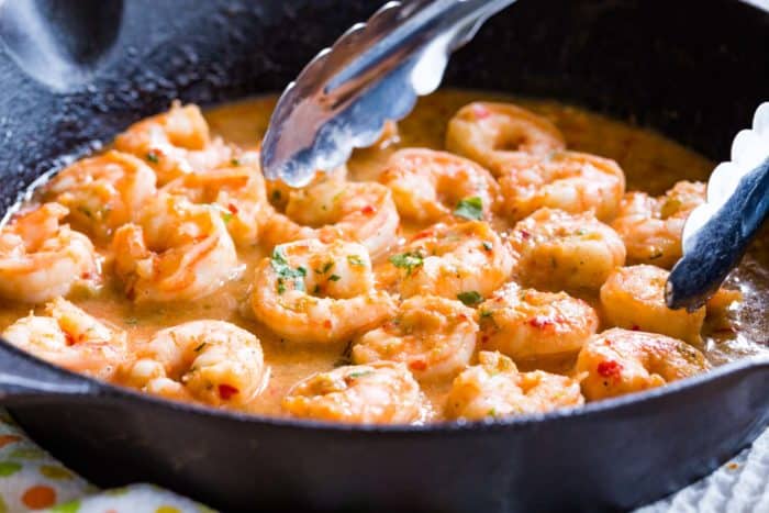 Cast Iron Skillet Chili Lime Shrimp with tongs in a pan