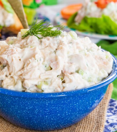 Tzatziki Chicken Salad in a bowl topped with a sprig of fresh dill