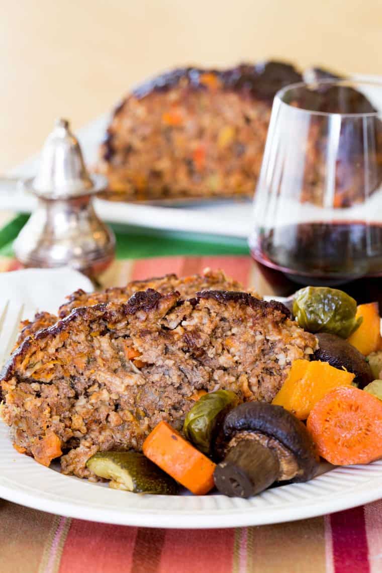 Slices of Balsamic Meatloaf on a plate with roasted vegetables