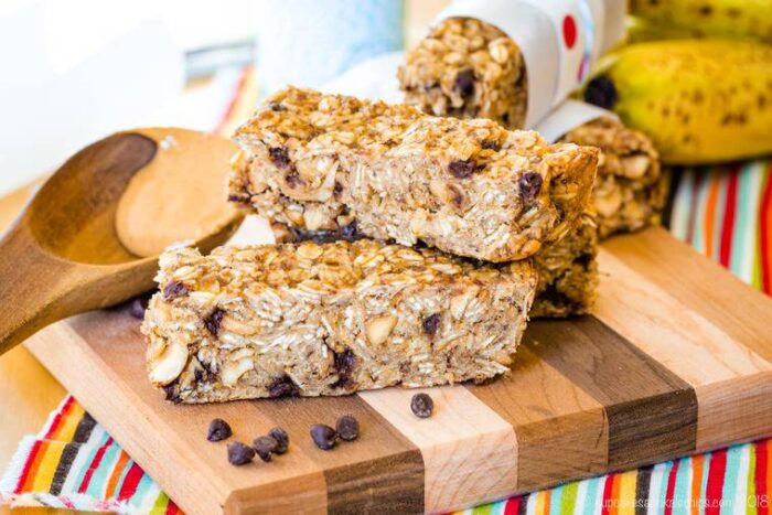 Banana Chocolate Chip Peanut Butter Granola Bars stacked on a cutting board