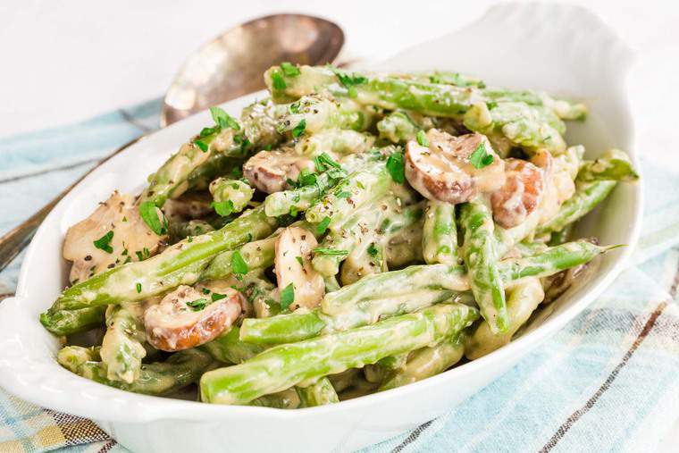 Creamy Green Beans with Mushrooms sprinkled with parsley and pepper