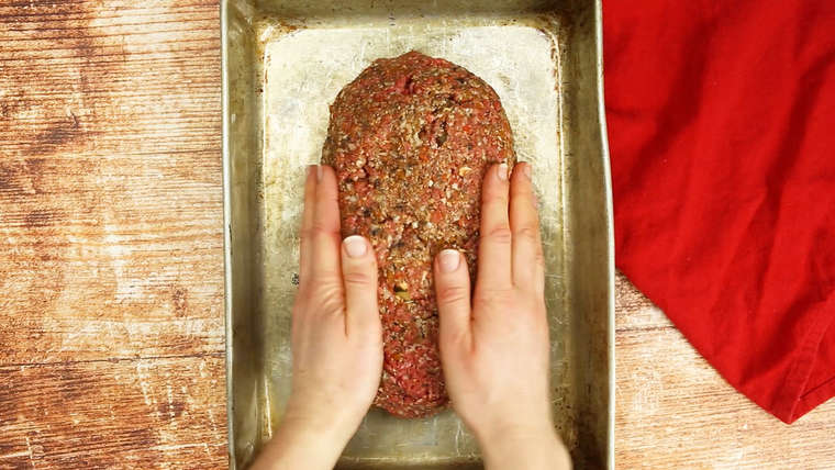 Pressing meatloaf together in baking pan