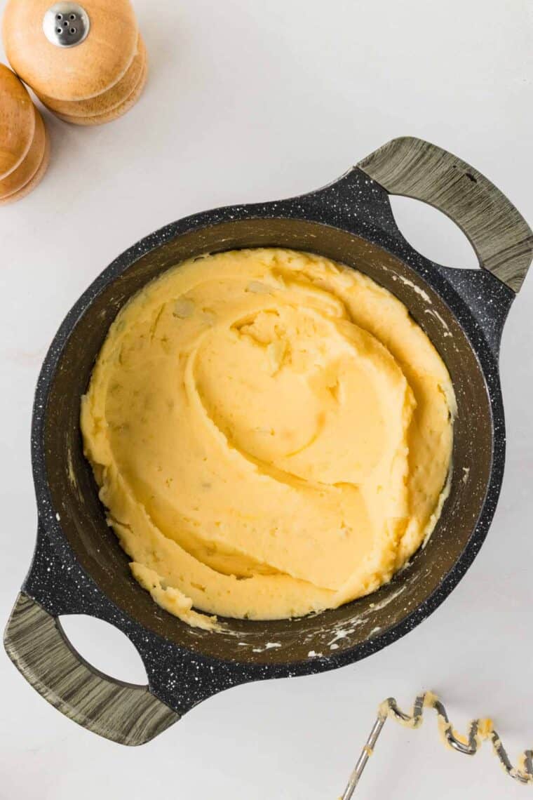 Cheesy mashed potatoes in a pot