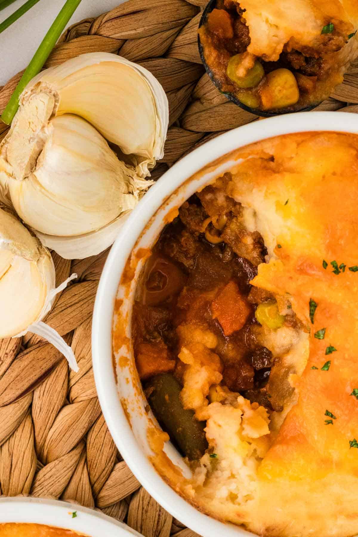 Overhead view of a mini shepherd's pie with a few bites of crust missing