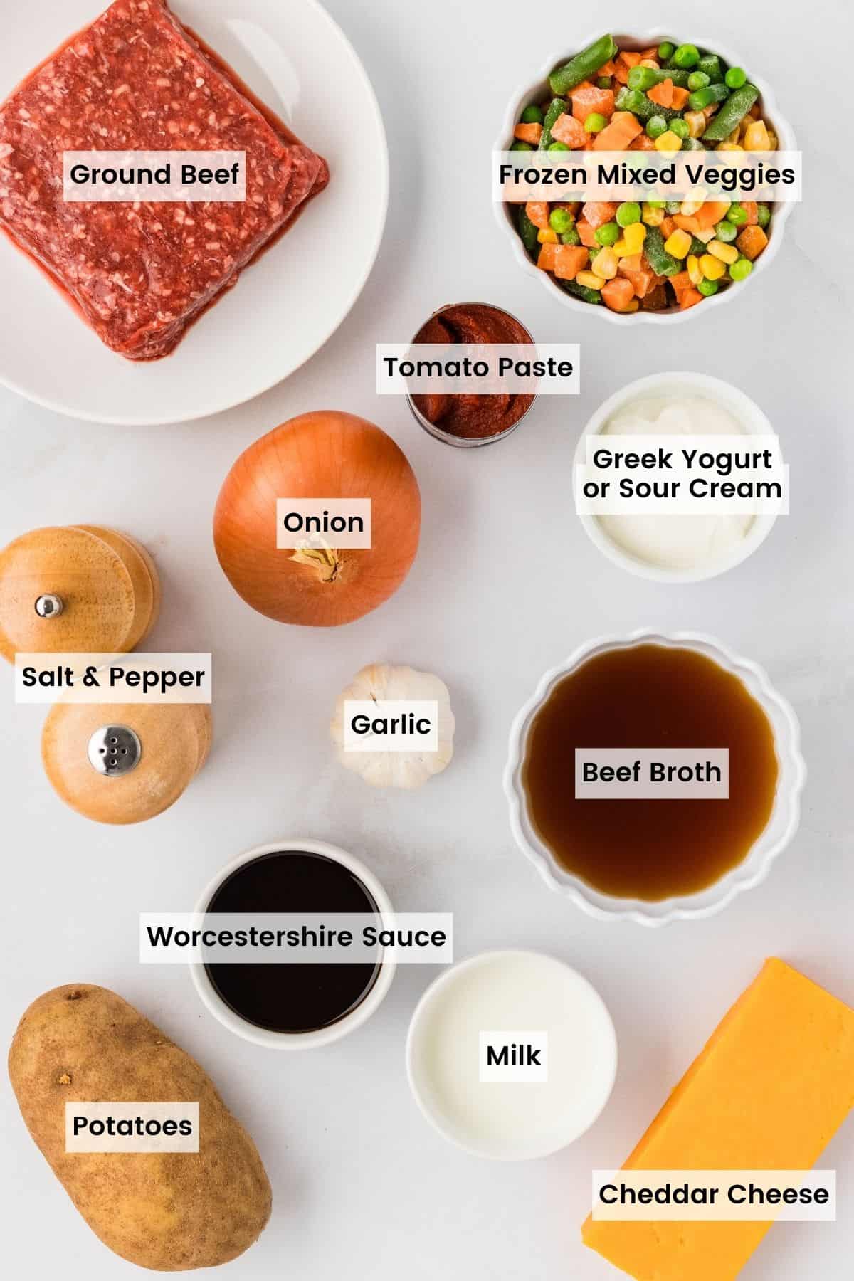 Overhead view of the labeled ingredients needed to make mini shepherd's pies
