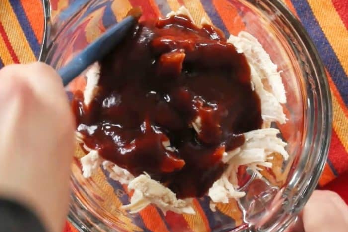 Mix shredded chicken with barbecue sauce